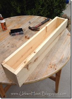 a wooden table with tools on it and some wood planks around the edge that are being used to make a bench