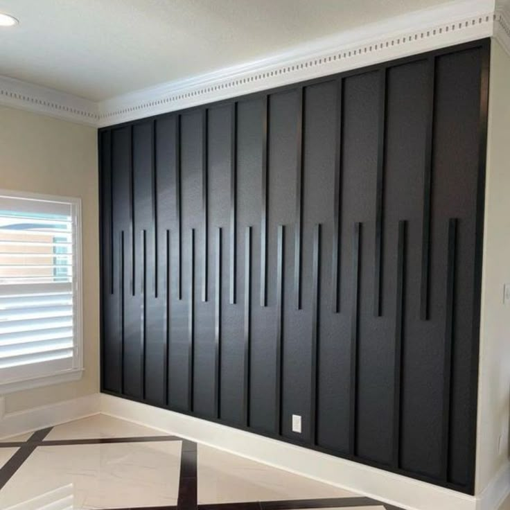 an empty room with black and white tiles on the floor