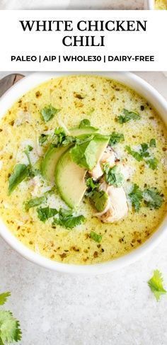 white chicken chili in a bowl with avocado and cilantro on top