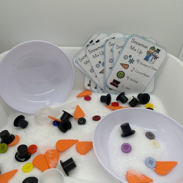 three white bowls filled with different types of buttons and magnets on top of a table