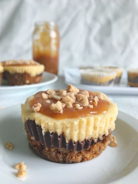 two desserts sitting on top of white plates with peanut butter and caramel topping