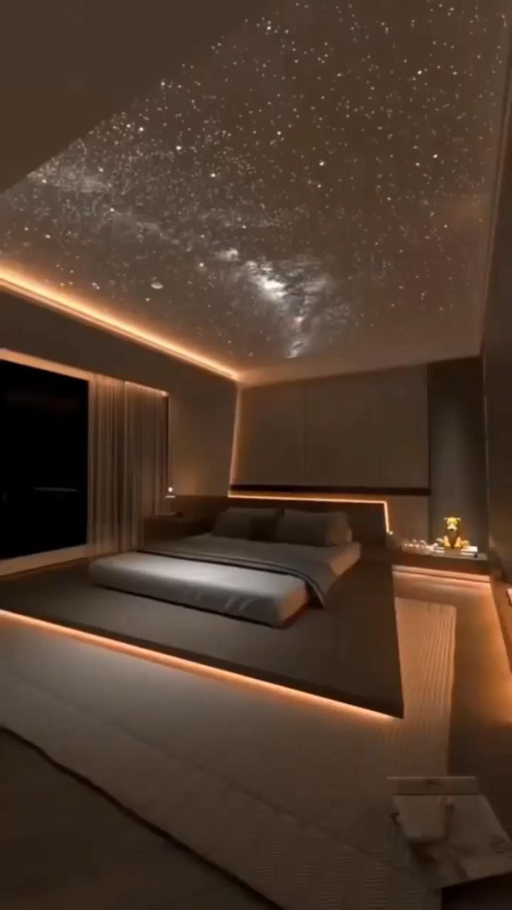 a large bed sitting under a sky filled with stars