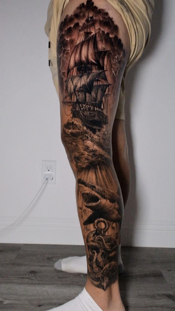 a man's leg with a ship on it