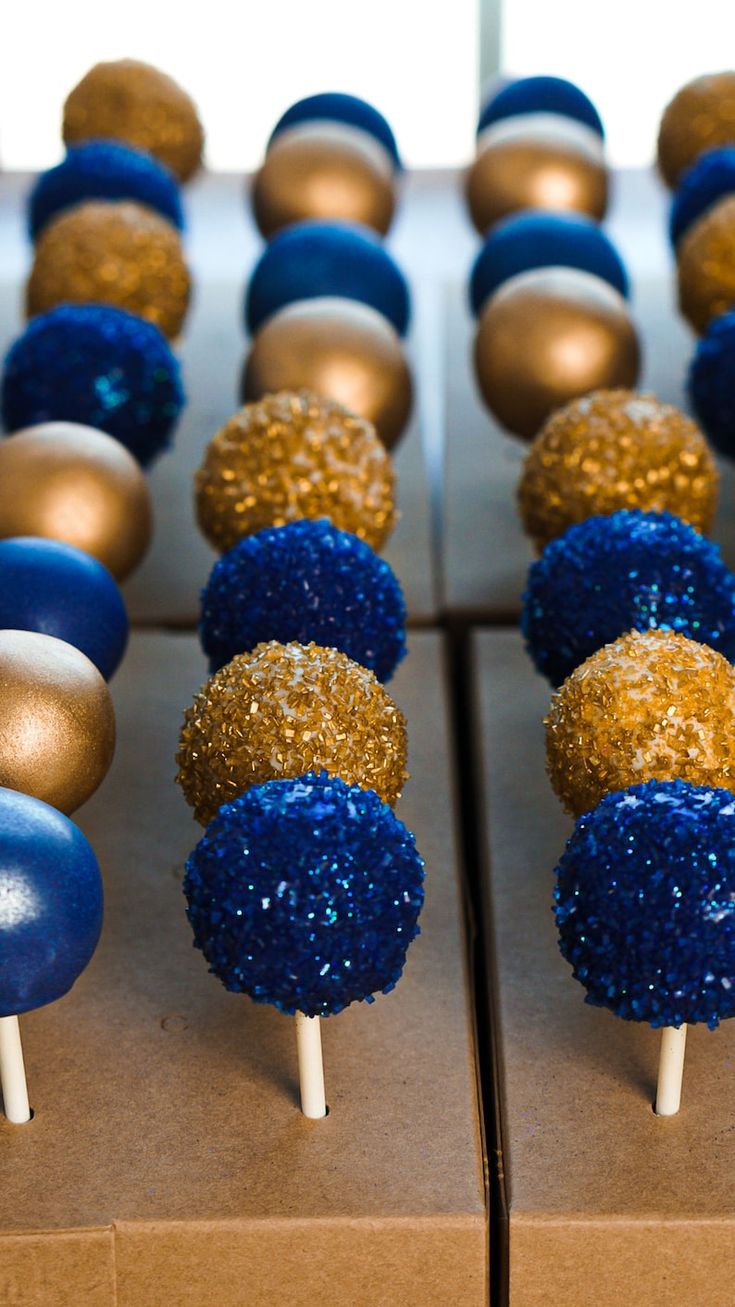 blue, gold and white cake pops are lined up