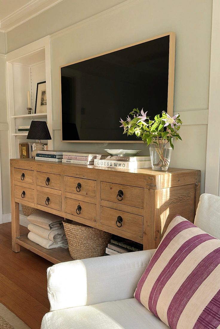 a living room with a large television mounted on the wall