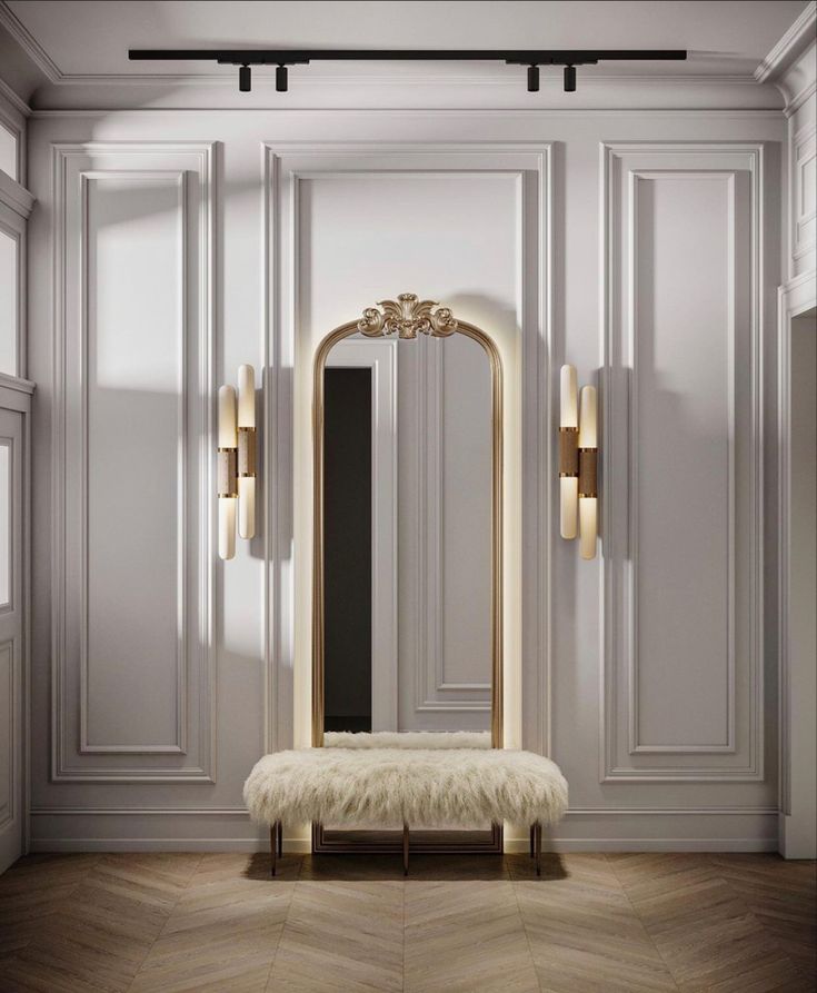 a room with a bench, mirror and two lights on the wall next to it