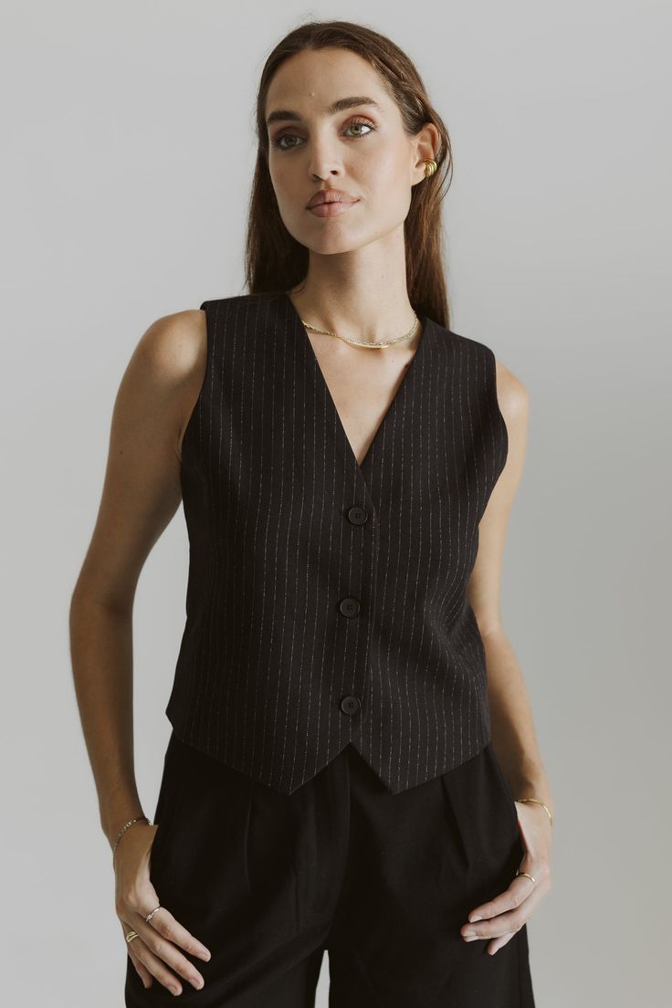 Information Featuring a traditional slim silhouette, The Kenz Vest creates a streamlined and tailored look that is both modern and timeless. Featuring a front button closure and added lining for comfort, this waistcoat vest is a classic element of formal wear, providing a touch of sophistication and style to any outfit. It can also be worn as a standalone piece with The Kenz Pants for a modern, tailored-casual look. Details Self: 66% Polyester, 32% Rayon, 2% Spandex Lining: 100% Polyester Fitted Classic V-neck Office Vest, Elegant V-neck Vest For Office Wear, Elegant Semi-formal Spring Vest, Tailored Vest With Button Closure For Workwear, Classic Single-breasted V-neck Vest, Elegant Single Breasted V-neck Vest, Elegant Single-breasted V-neck Vest, Elegant V-neck Vest For Formal Occasions, Elegant Fitted Nehru Jacket For Workwear