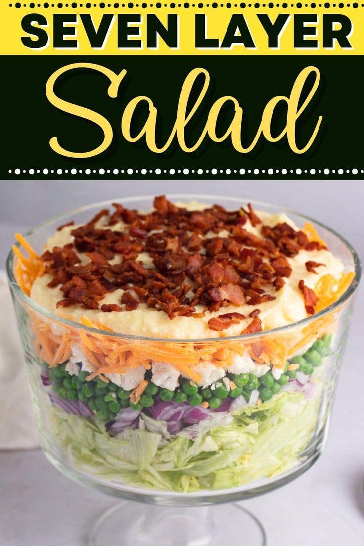 a salad in a glass dish with bacon on top and the words seven layer salad above it