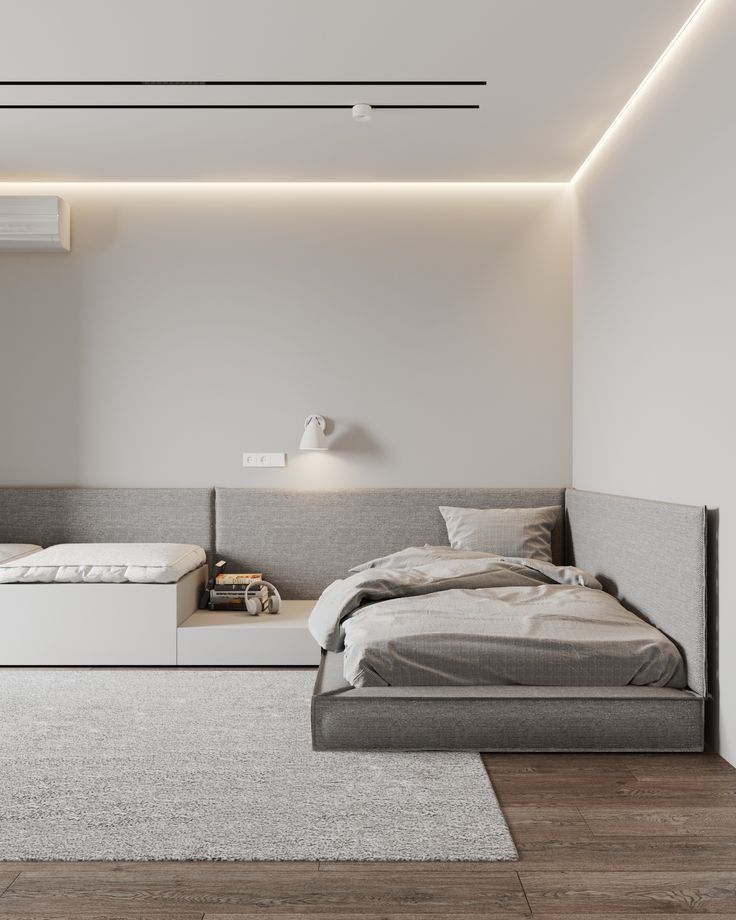 a bed sitting in the middle of a bedroom next to a white wall and floor