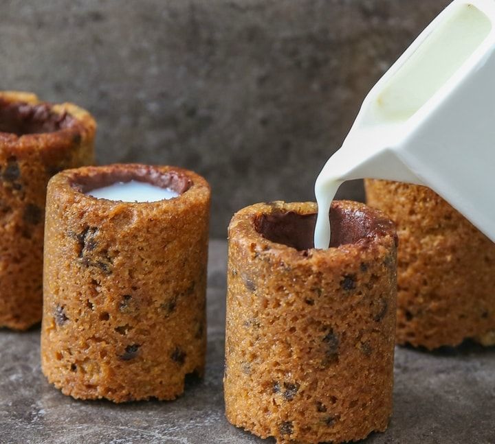 chocolate chip cookie cups being poured with milk