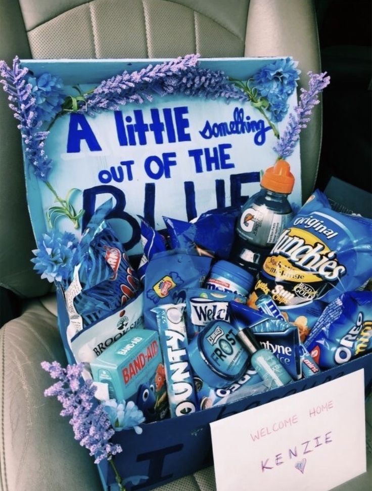 a car seat with a sign and some snacks in it