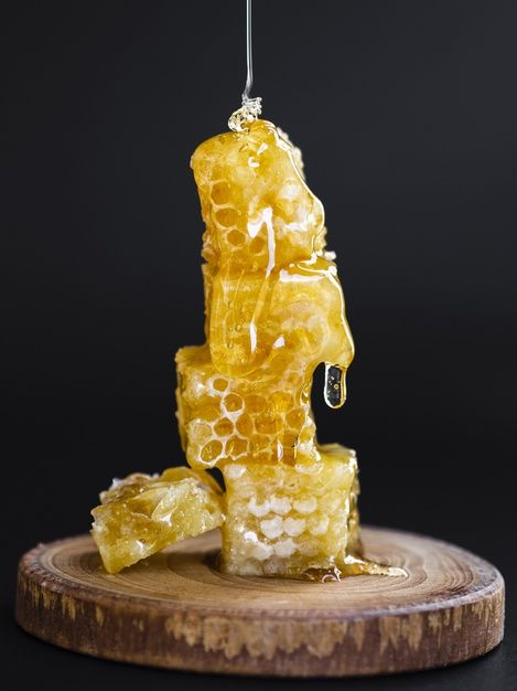 a piece of honey sitting on top of a wooden board