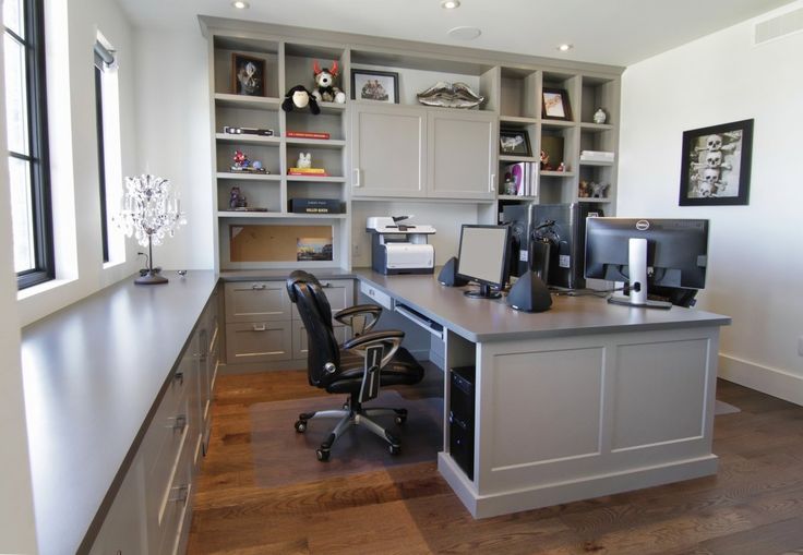 an office area with desk, computer and cabinets