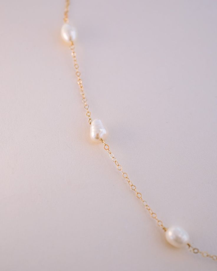 A stunning and dainty statement piece, the Leighton Pearl Necklace features an exquisite display of pearls that's sure to mesmerize and bring life to any ensemble! With its perfect blend of elegance, beauty, and sophistication, this pearl necklace is the ideal finishing touch for any special occasion. To complete your look, pair the Leighton Pearl Necklace with the Leighton Pearl Bracelet! NECKLACE FEATURES Materials: Brass, Freshwater Pearls, Sterling Silver, 14K Gold Hand wire wrapped genuine Rose Gold Pearl Necklace, Freshwater Pearls Earrings, Gold Hands, Pretty Earrings, Lariat Necklace, Opal Necklace, Delicate Necklace, Polish Jewelry, Gold Filled Jewelry