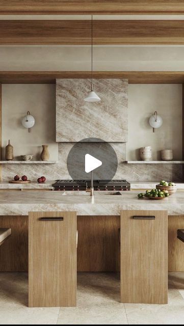 a kitchen with marble counter tops and wooden cabinetry, along with an island in the middle