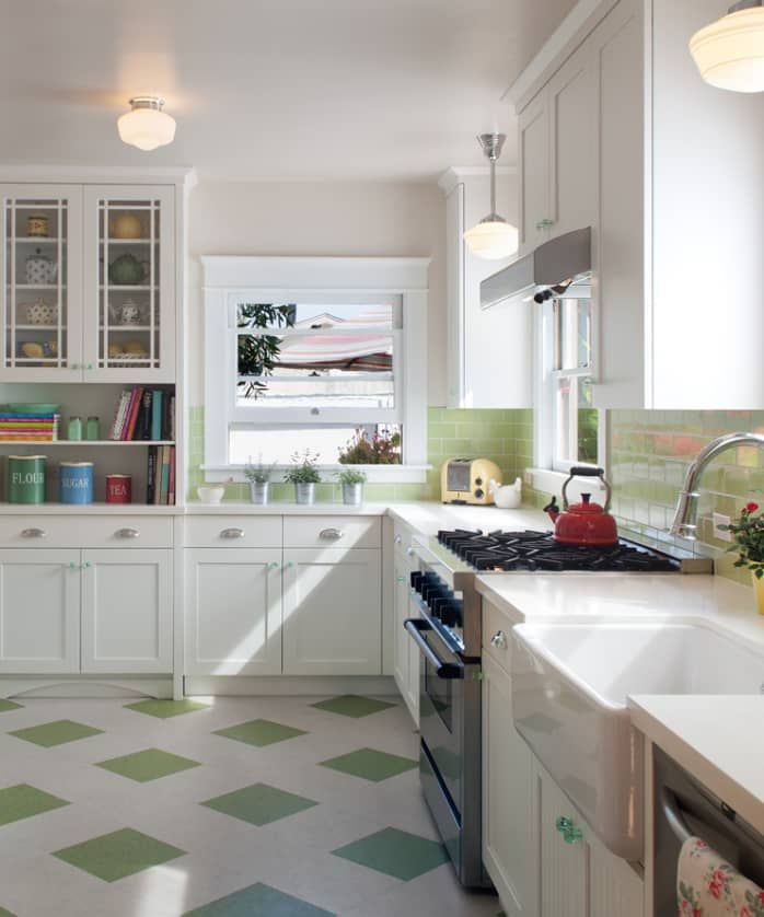 a kitchen with green and white checkered flooring on the walls, cabinets and drawers