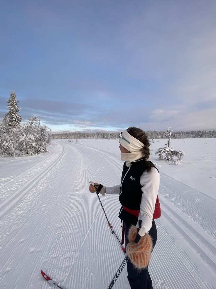 a woman is cross country skiing in the snow