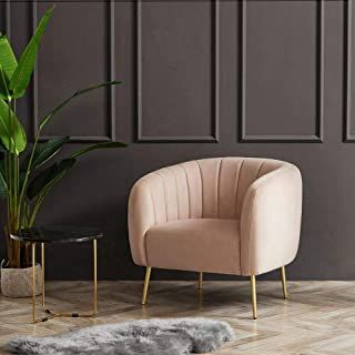 a living room with a chair, table and potted plant on the floor next to it