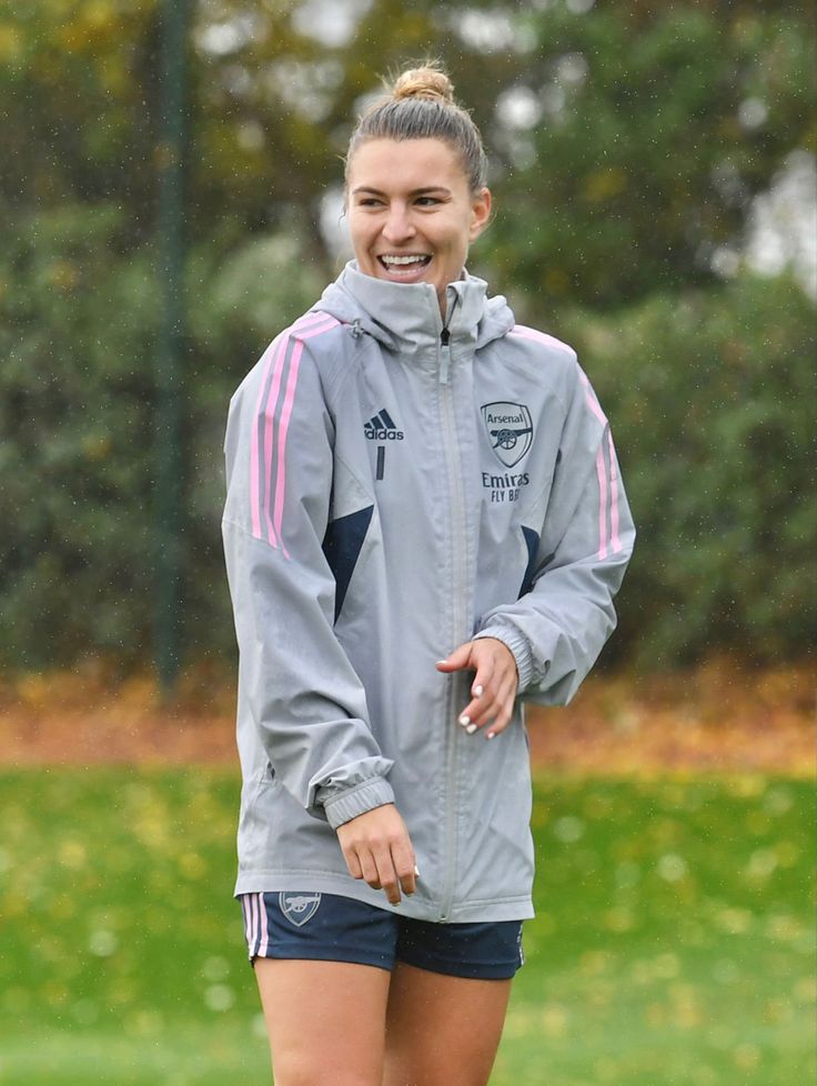 a woman standing on top of a soccer field