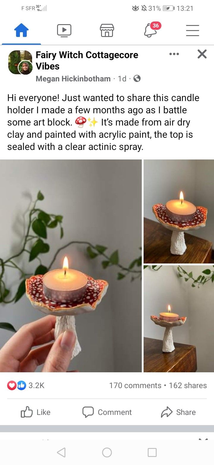 someone is holding a candle in their hand and it looks like they are trying to make something