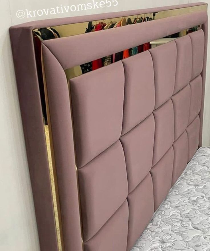 an upholstered headboard with magazine holders on it's sides, in front of a white wall