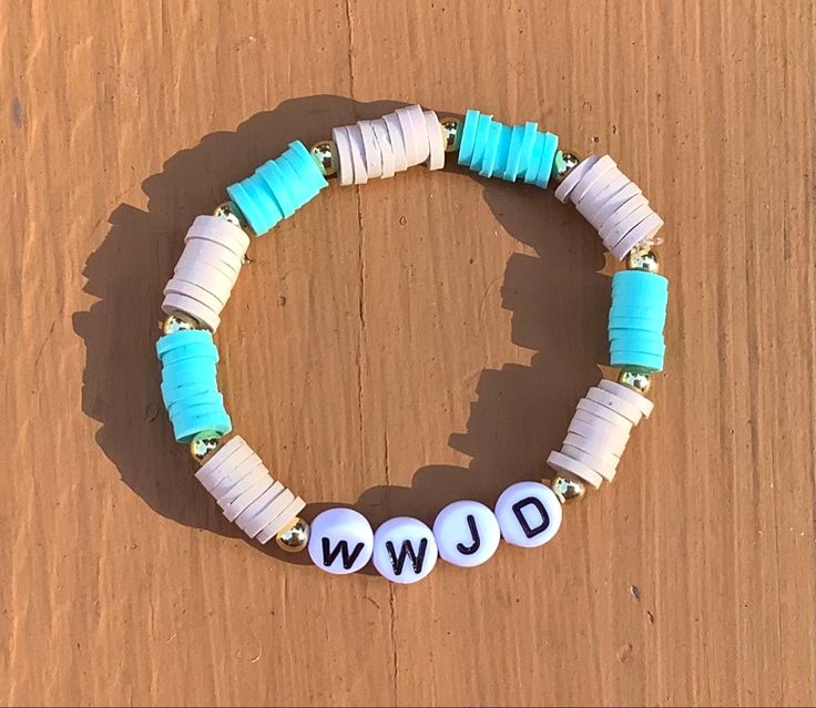 a beaded bracelet with the word jwj written on it and beads attached to it