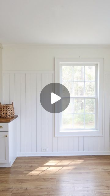 an empty living room with white walls and wood flooring is featured in this video