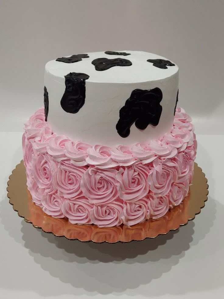 a decorated cake with pink and black frosting