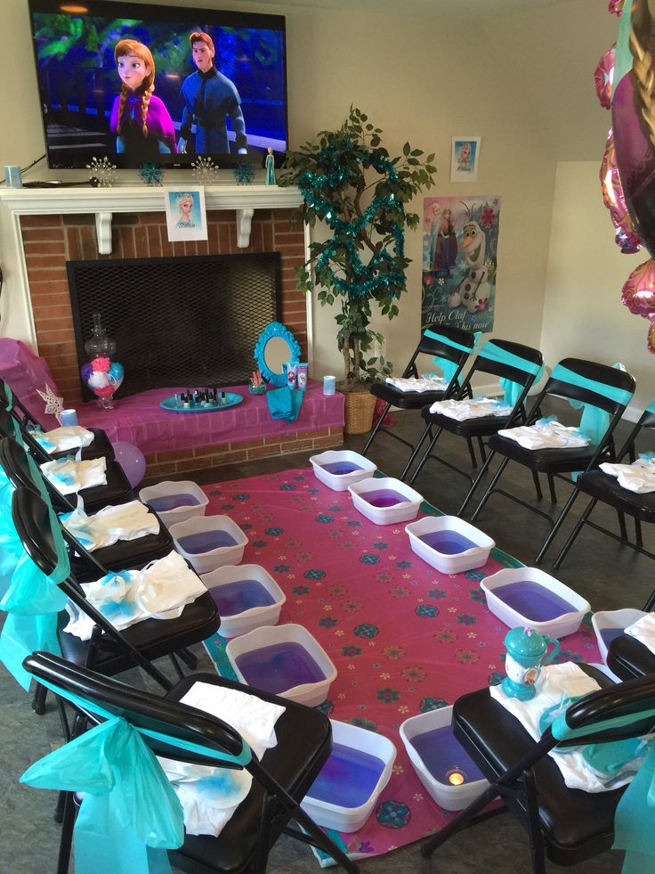 there are many tables and chairs set up in front of the tv with decorations on them