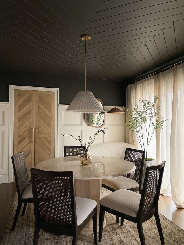 a dining room table with four chairs around it