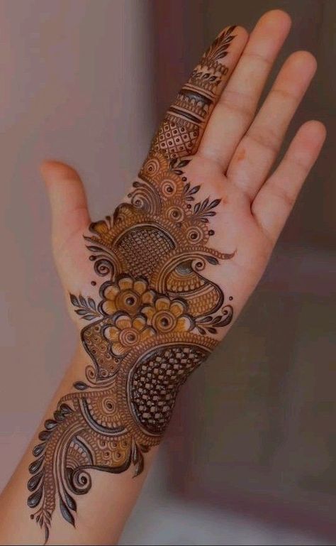 a woman's hand with henna on it