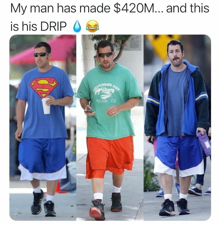 three men walking down the street with one wearing a superman t - shirt and shorts