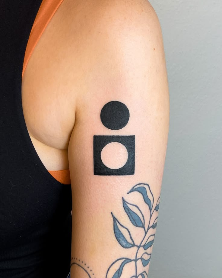 a woman's arm with a camera tattoo on the left side of her body