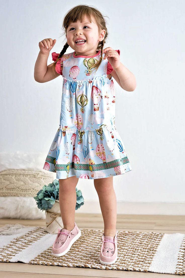 DESCRIPTION Experience a dreamlike moment with our Bella's balloon ruffle tiered dress, featuring a one-of-a-kind print and playful ruffles. Add a touch of quirkiness and stand out from the crowd with this fun and stylish piece. Blending cotton with spandex in baby garments can offer several benefits: Stretch and Flexibility: Spandex, also known as elastane, is a highly elastic fiber. When blended with cotton, it imparts stretchiness and flexibility to the fabric. Comfort: The combination of cot Ruffle Tiered Dress, Bleach Product, Baby Garments, Dress Birthday, Printed Balloons, Birthday Gifts For Kids, Tiered Dress, Birthday Dresses, Simple Dresses