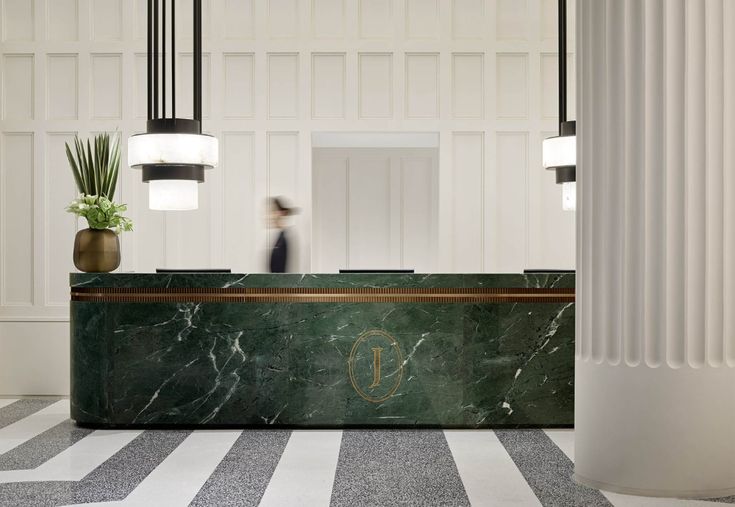 a marble reception desk in an elegant lobby