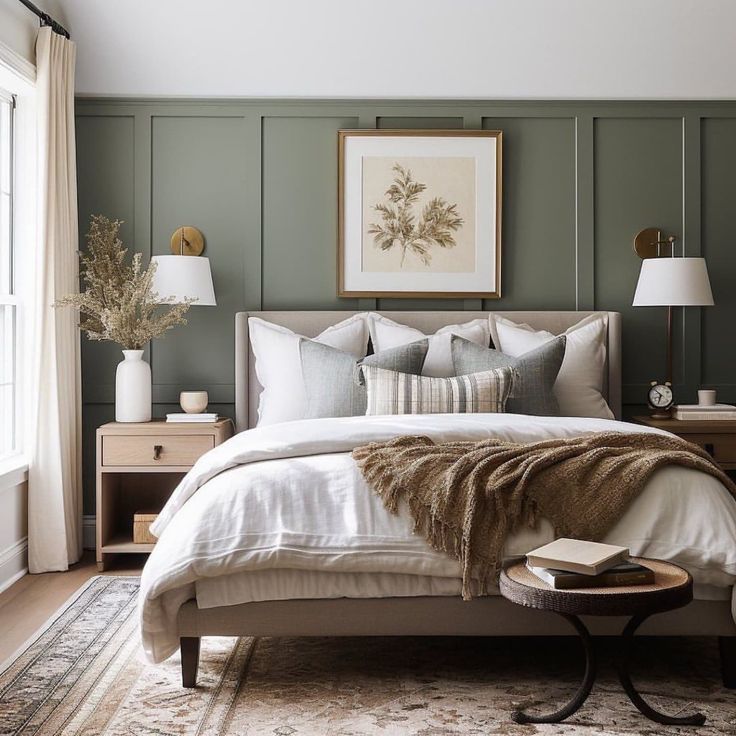 a bedroom with green walls and white linens on the bed, along with two nightstands