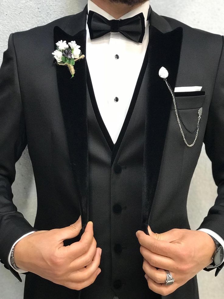 a man in a tuxedo with a boutonniere on his lapel