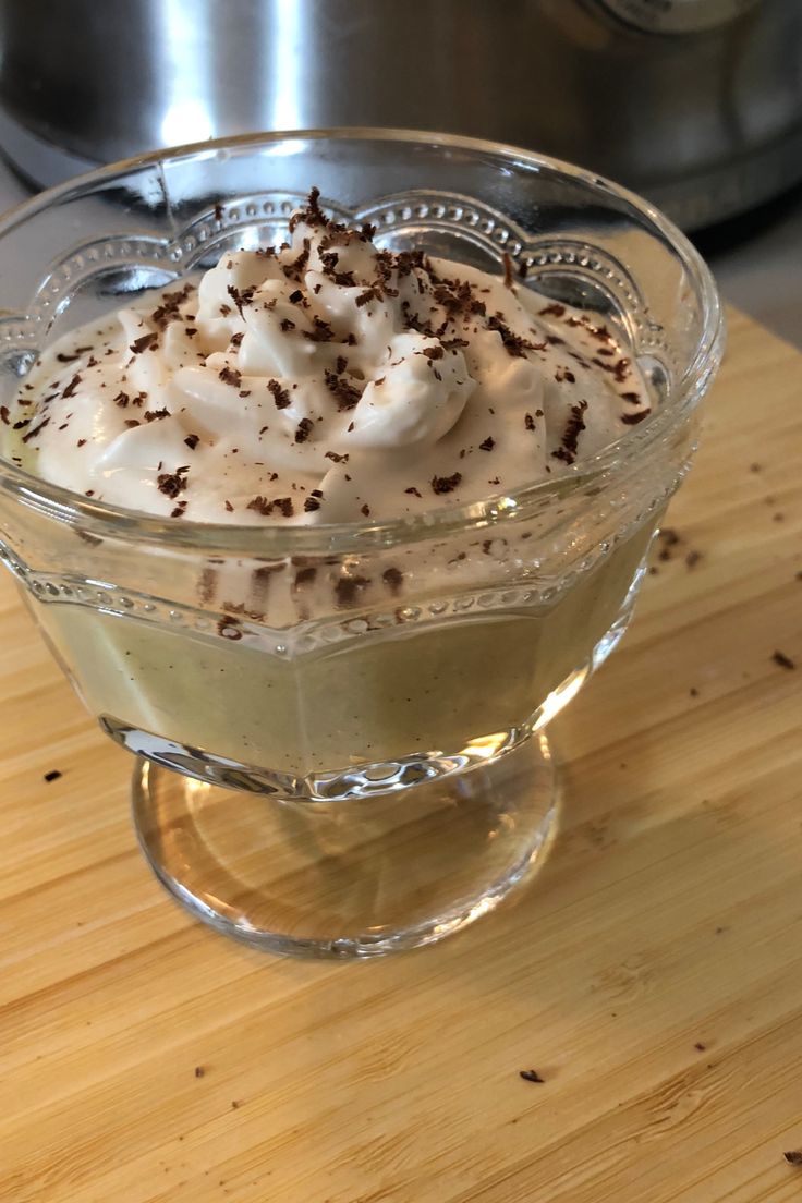 a dessert in a glass dish on a wooden table