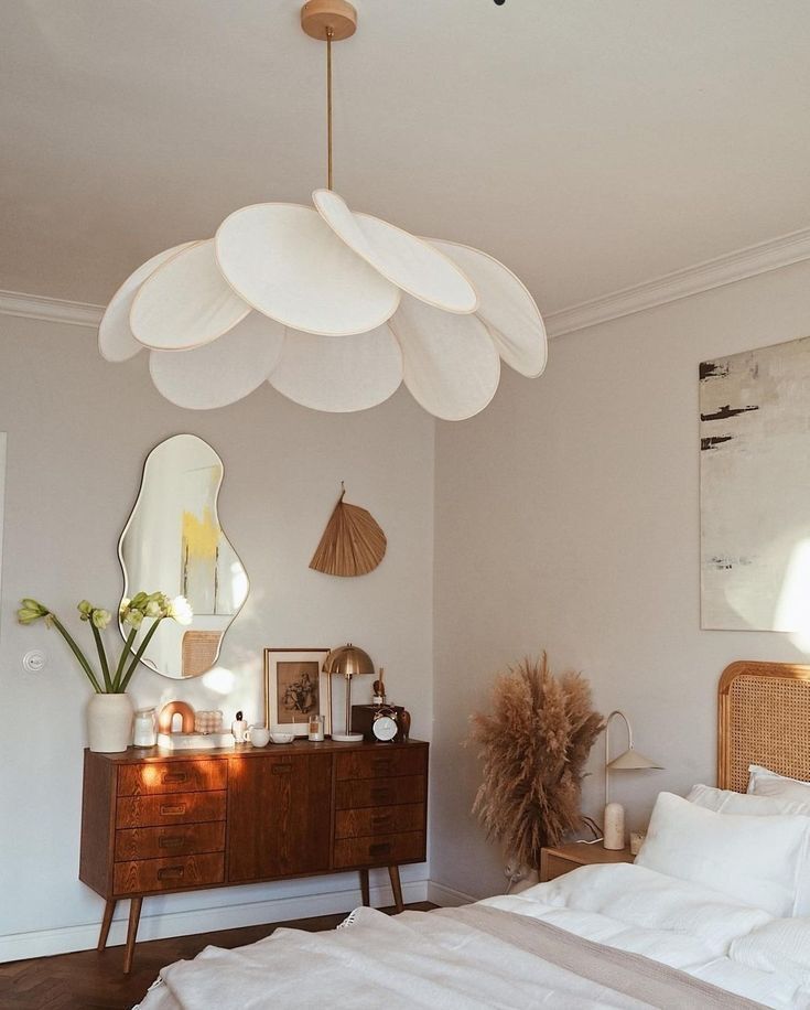 a bedroom with a bed, dresser and mirror on the wall next to each other