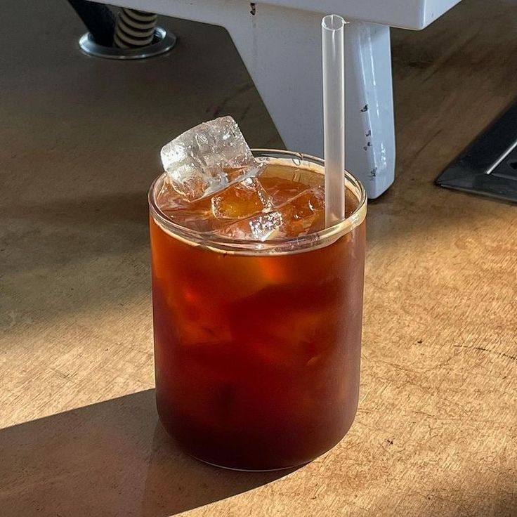 a drink in a glass with ice on the table