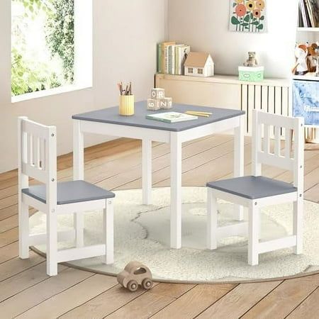 a child's table and two chairs in a room