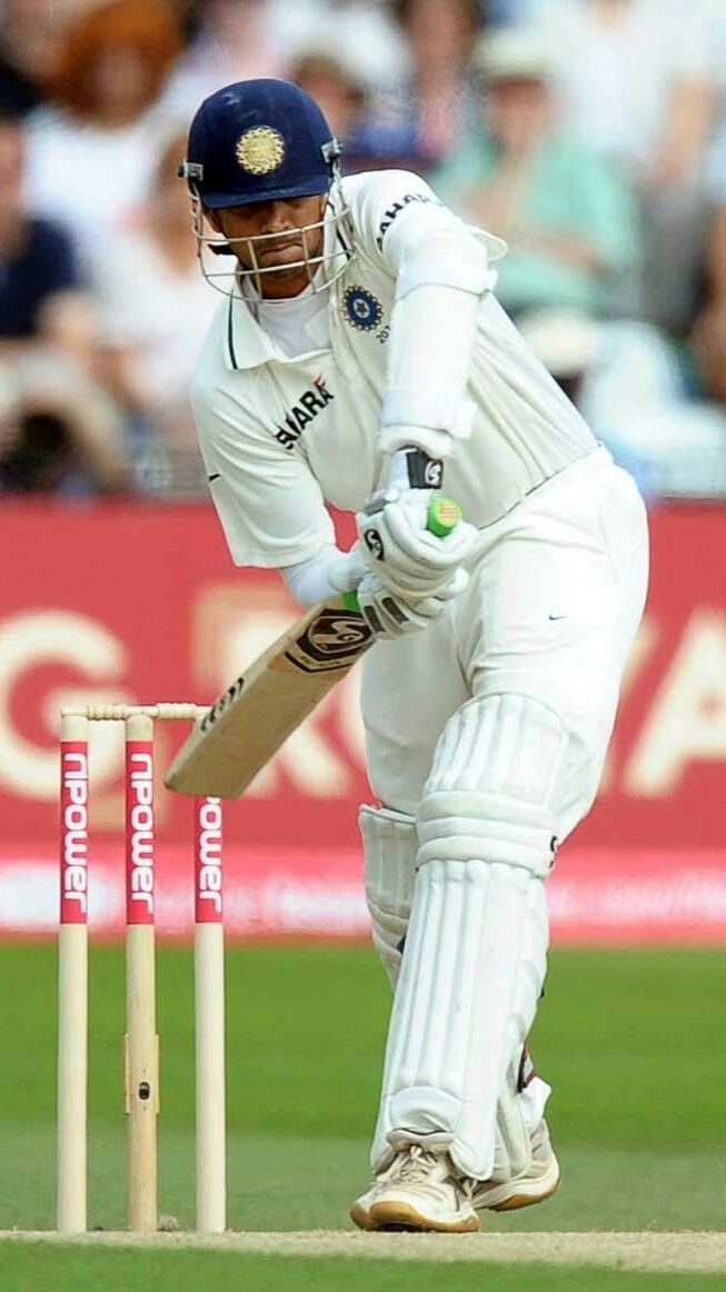 a man in white uniform playing a game of cricket