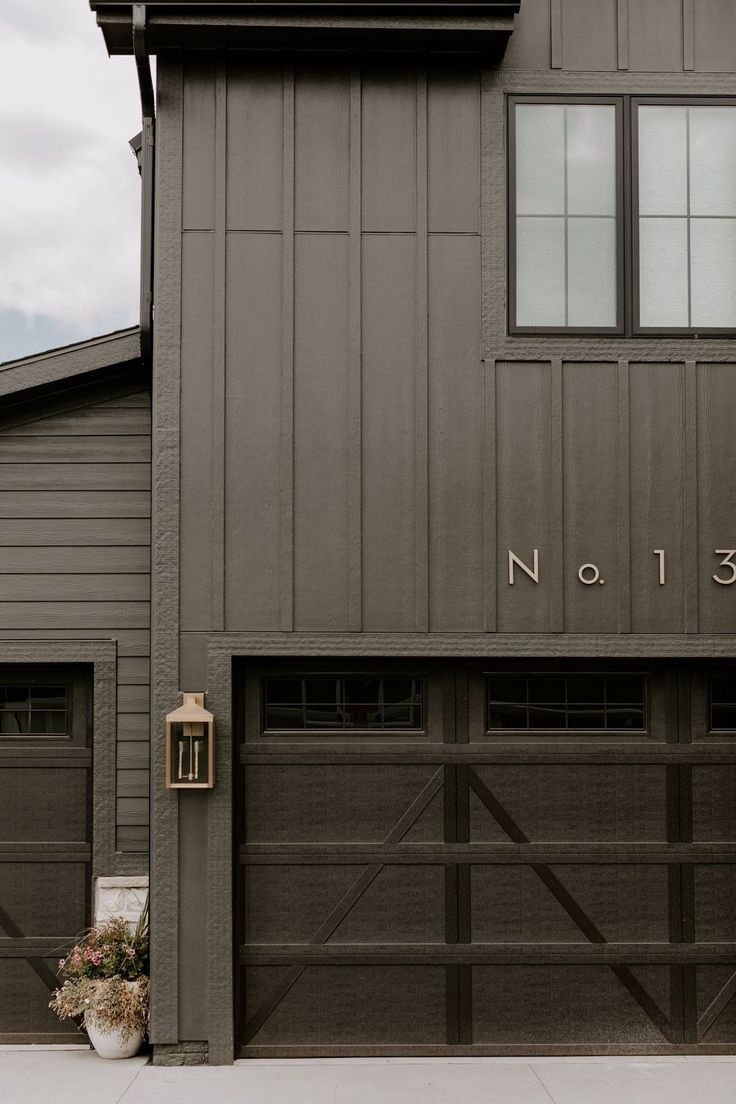 two garage doors are open on the side of a building with no 13 written on it