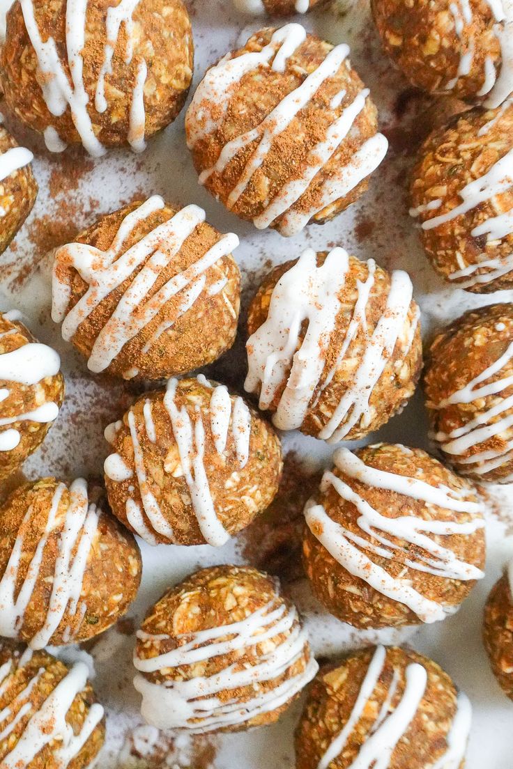 a white plate filled with cookies covered in icing and drizzled on top