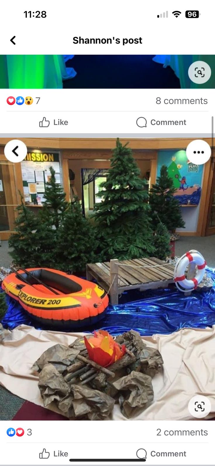 an inflatable raft is on the ground next to some trees and other items