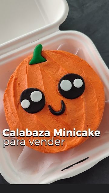 a cupcake decorated like a pumpkin with googly eyes