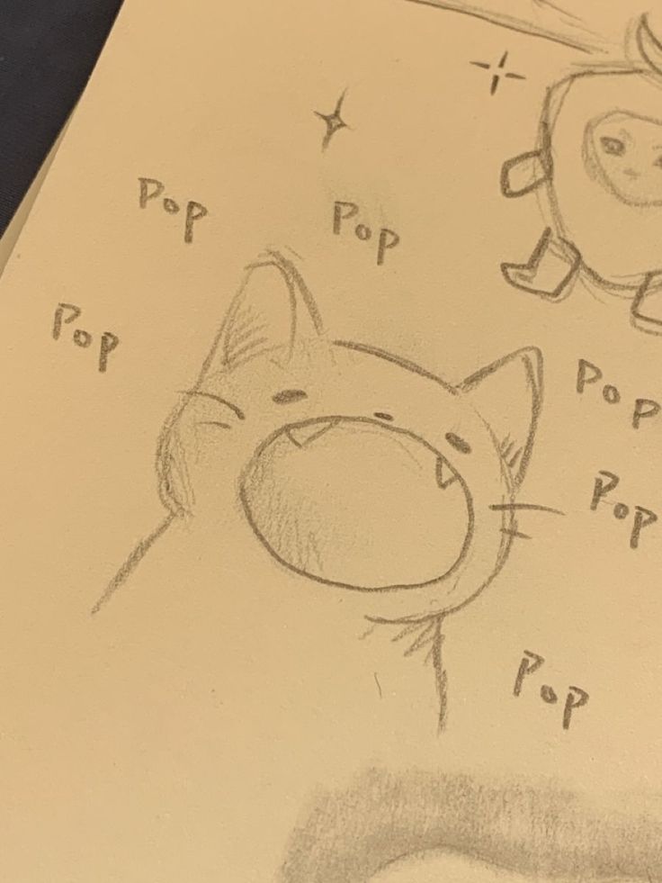 a drawing of a cat and an apple with pop pop on it's face