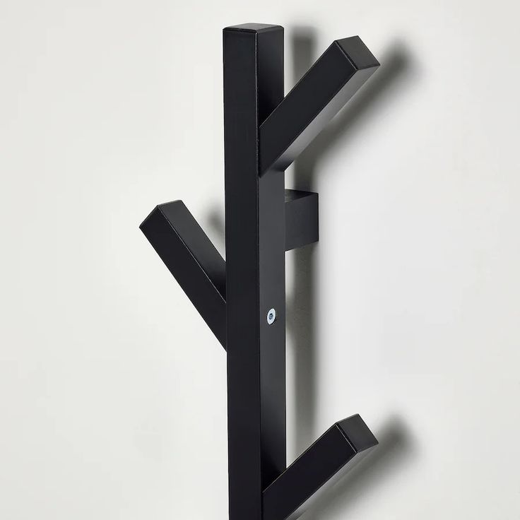 a black coat rack with two hooks on it