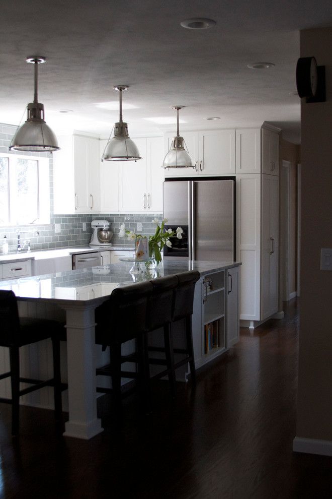 a kitchen with an island and three lights