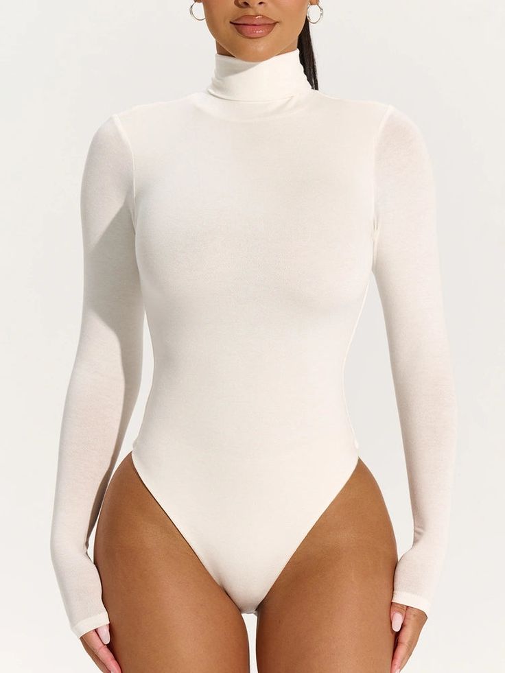 Our classic Fall and Winter bodysuit has arrived in a turtleneck design, long fitted sleeves and a bodycon finish. Thong cut in the back with snap closures down below. Pair this with your favorite bottoms to create casual or dressed up fits. Xx NW Collection Import 95% Polyester, 5% Spandex Model wears size X-Small in Black Model wears size Small in Espresso True to size This bodysuit is double-lined All Bodysuits Are Final Sale. Sleek Turtleneck Second-skin Bodysuit, Sleek Second-skin Turtleneck Bodysuit, Chic Long Sleeve Elastane Bodysuit, Sleek High-stretch Bodysuit With Thumbholes, Fall Second-skin Bodysuit With Thumbholes, Sleek High-stretch Turtleneck Bodysuit, Sleek High Stretch Long Sleeve Bodysuit, Sleek High Stretch Turtleneck Bodysuit, Long Sleeve Bodysuit With Thumbholes